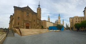 A large historic building with a prominent tower and a staircase leading to the entrance. - Hotel Hispania (Zaragoza)