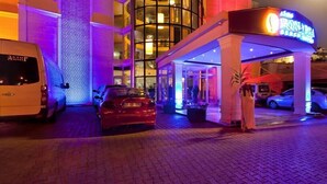 A hotel entrance with a modern design, featuring a glass facade and a neon sign. - Lims Bona Dea Beach Hotel – All Inclusive (Kemer)
