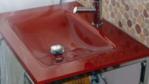 A red sink with a single faucet and a soap dish. - Le Terrazze del Vaticano (Rome)