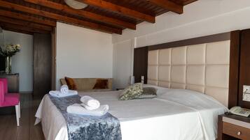 A hotel room with a bed, a bedside table, a chair, and a wooden ceiling.