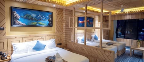 A hotel room with a large bed, a desk, a chair, and a TV.