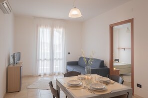 Premium Apartment, 1 Bedroom (for 4 people) | Living area | TV - Residence Le Fontane (Villasimius)