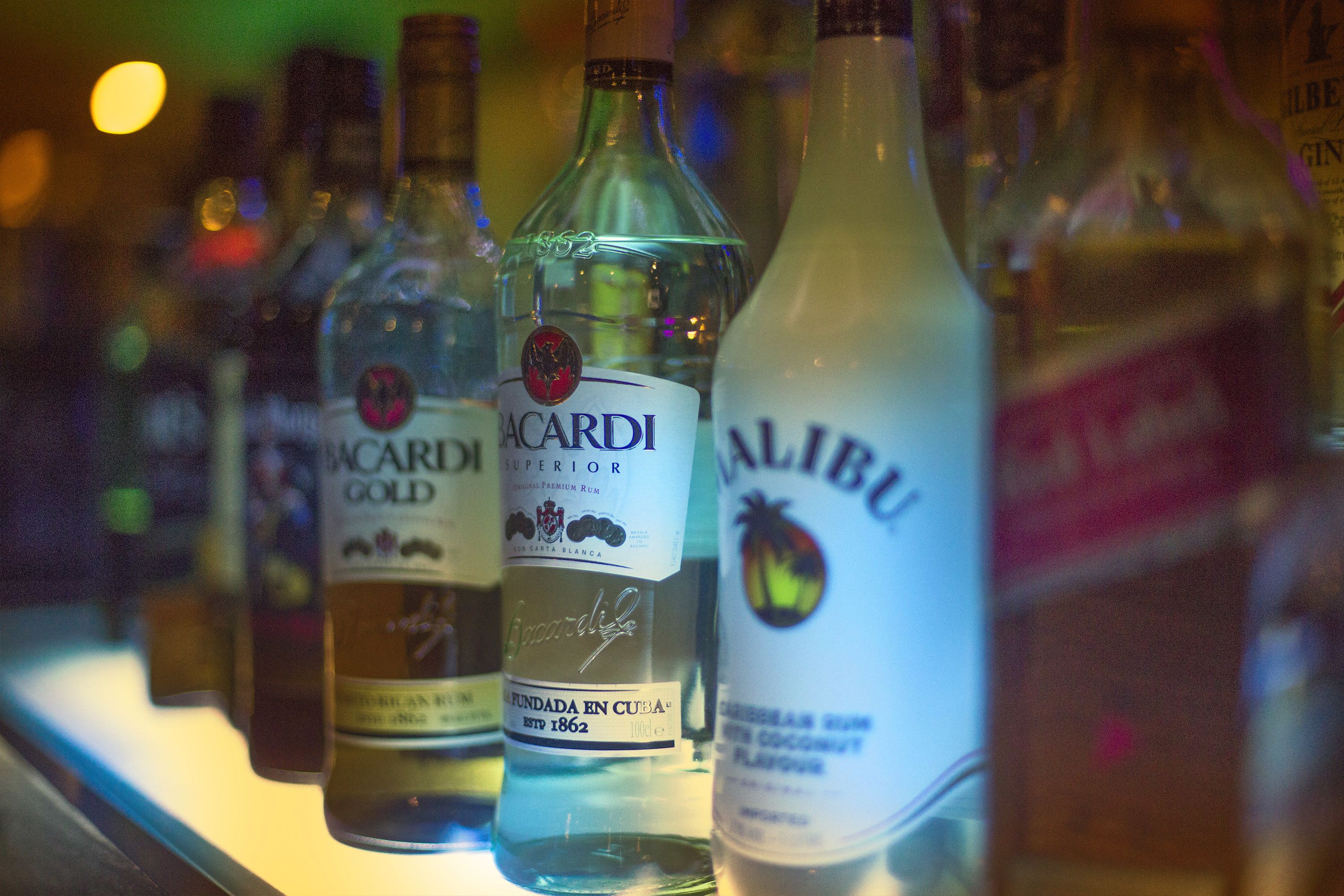 A selection of alcohol bottles on a shelf.