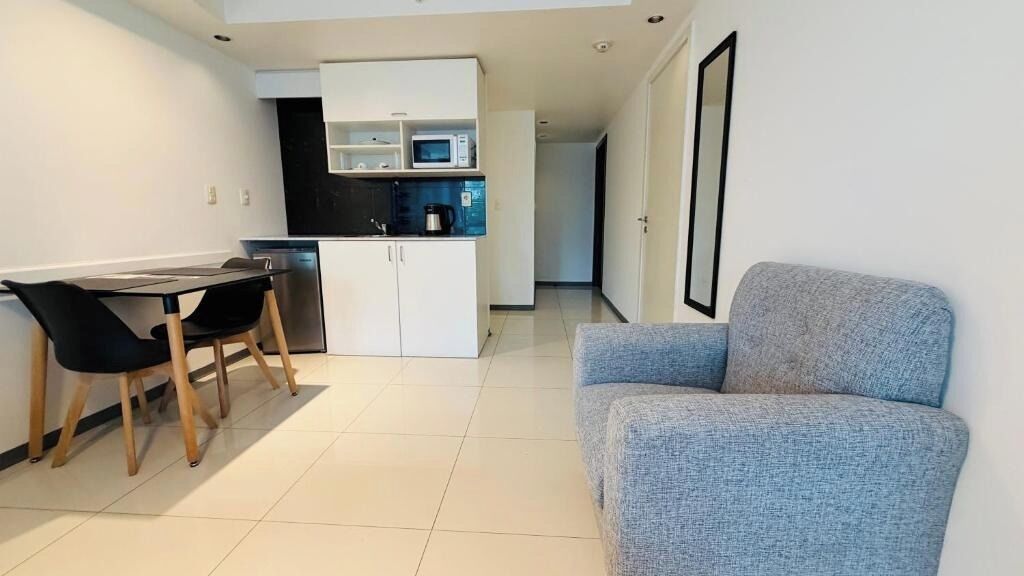 A compact living space with a kitchenette, a dining area, and a seating area.