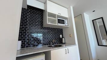 Fridge, microwave, coffee/tea maker, cookware/dishes/utensils