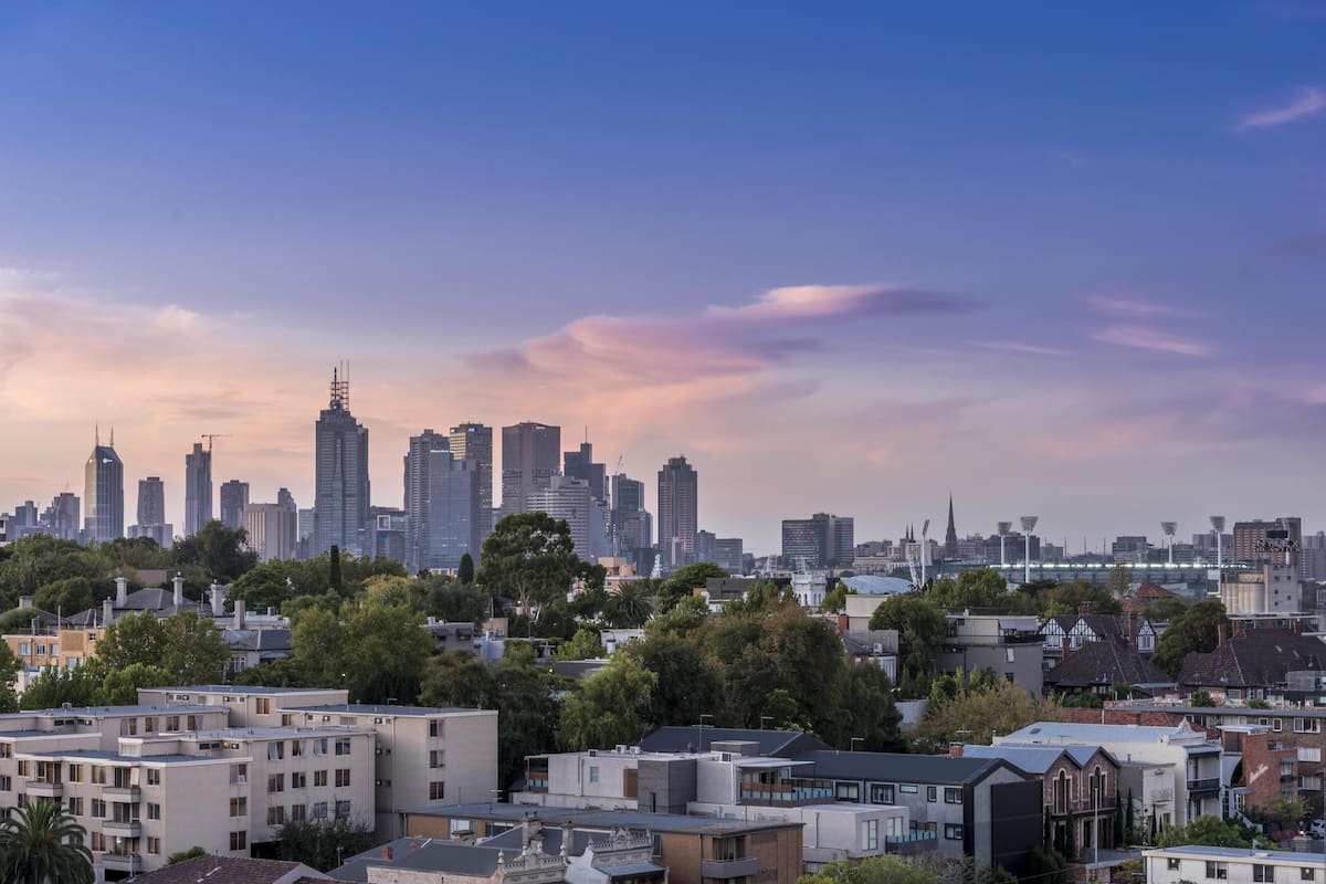 A cityscape with modern buildings and a mix of residential and commercial structures.