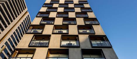 A high-rise building with multiple floors, large windows, and a modern architectural design.