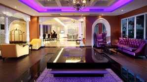 A spacious lobby with a chandelier, seating areas, and a reception desk. - Chillax Resort (Bangkok)