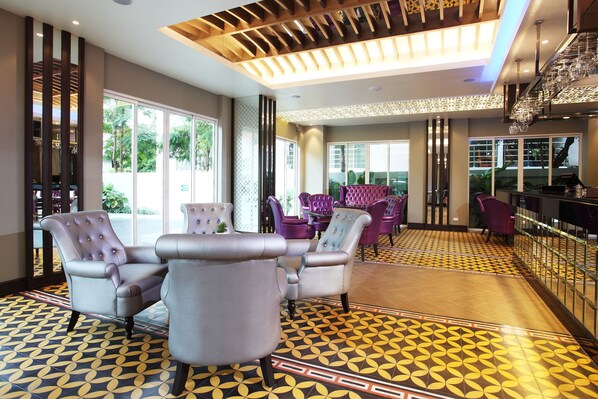 A spacious lobby with modern seating, large windows, and a patterned floor. - Chillax Resort (Bangkok)