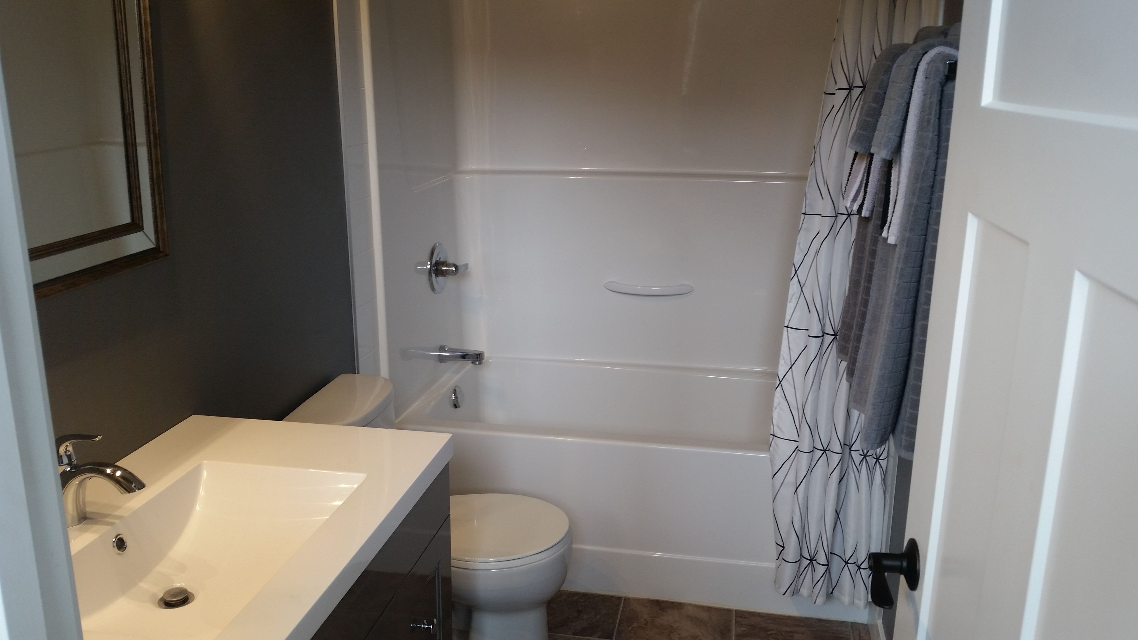 A bathroom with a white sink, toilet, and bathtub.