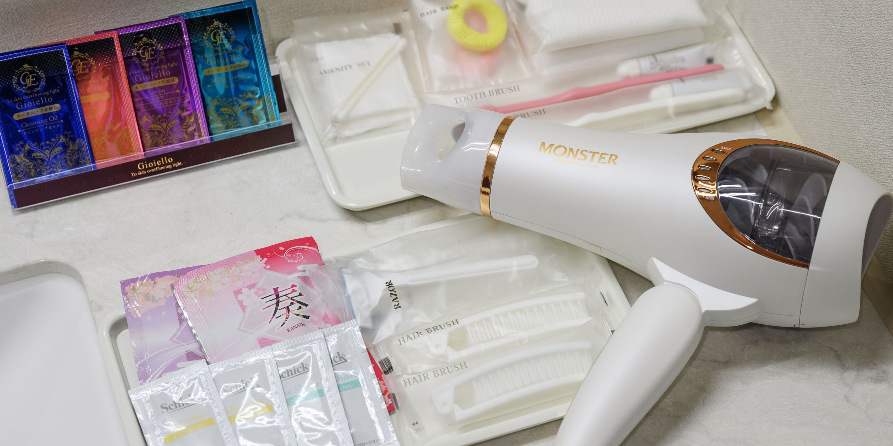 A hair styling device, hairbrushes, and hair care products on a countertop.
