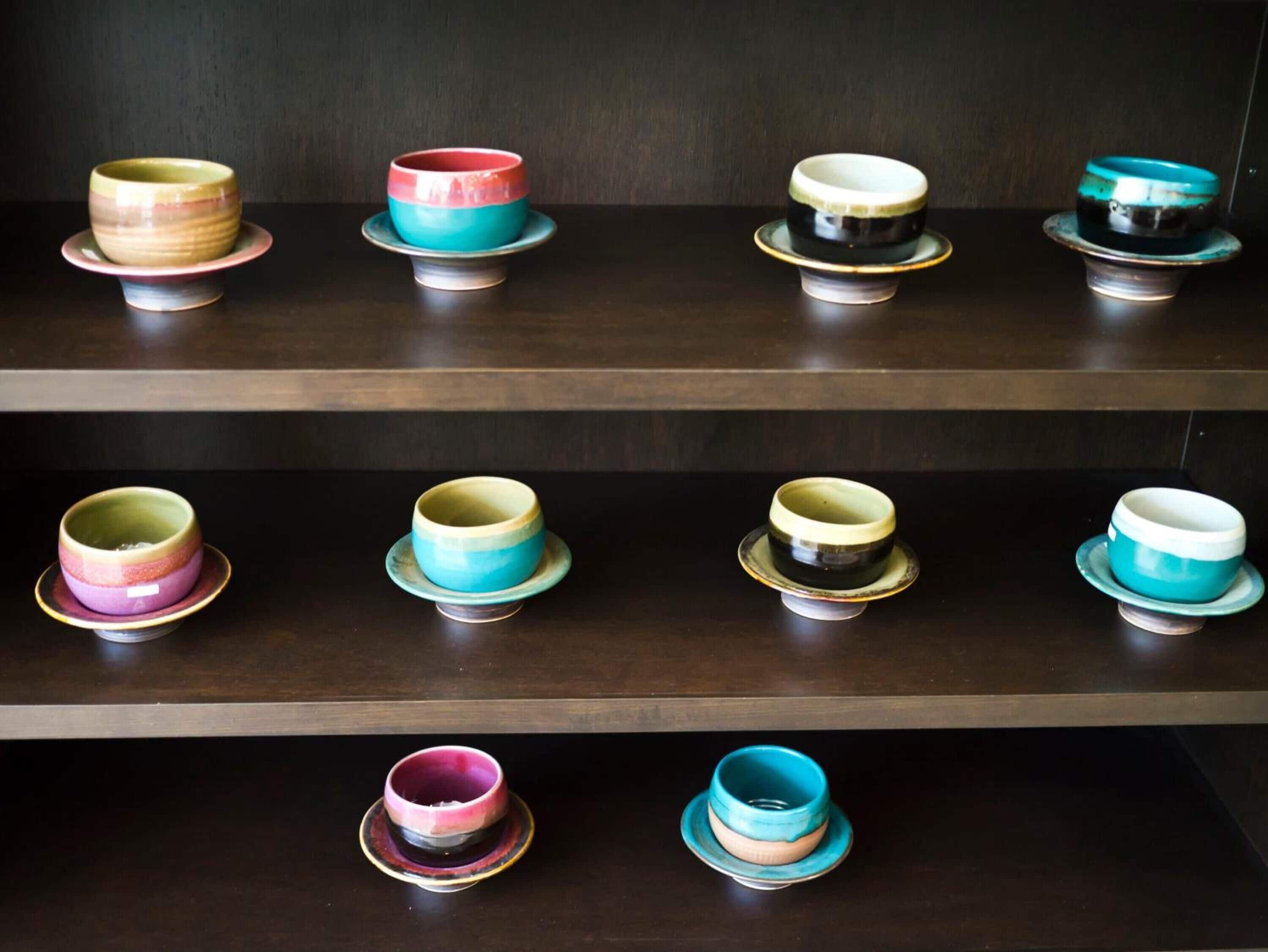 A collection of ceramic bowls on shelves.