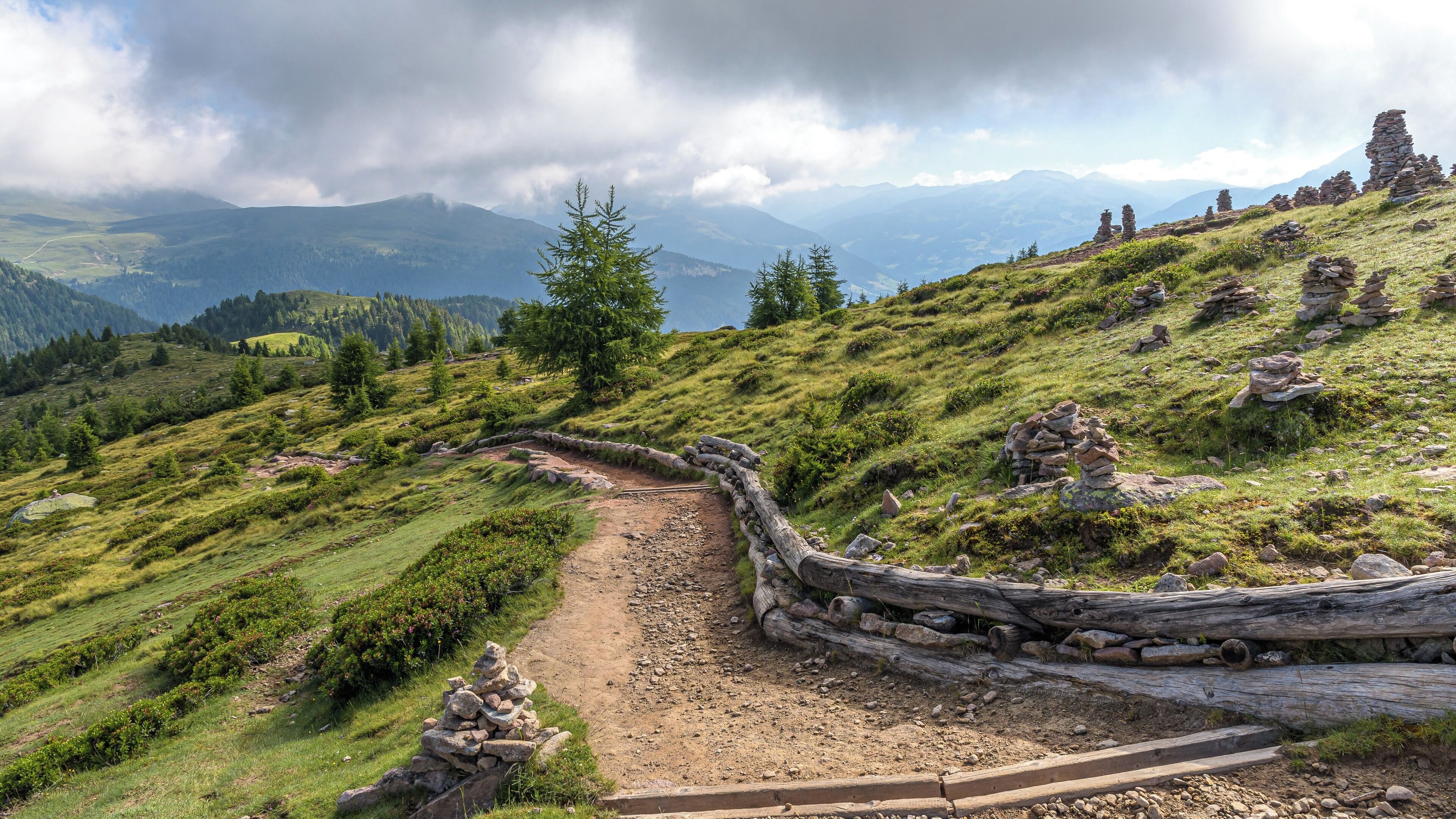 A mountain trail with stone walls and a wooden path.