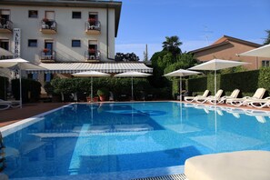 Seasonal outdoor pool, open 9:00 AM to 7:00 PM, pool umbrellas