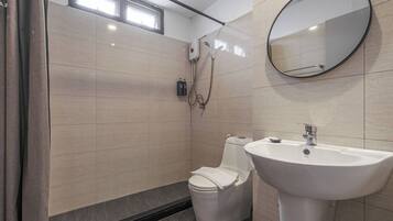 A modern bathroom with a toilet, sink, and shower.