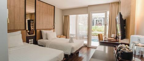 A hotel room with two beds, a TV, a coffee station, and a view of the outdoors.
