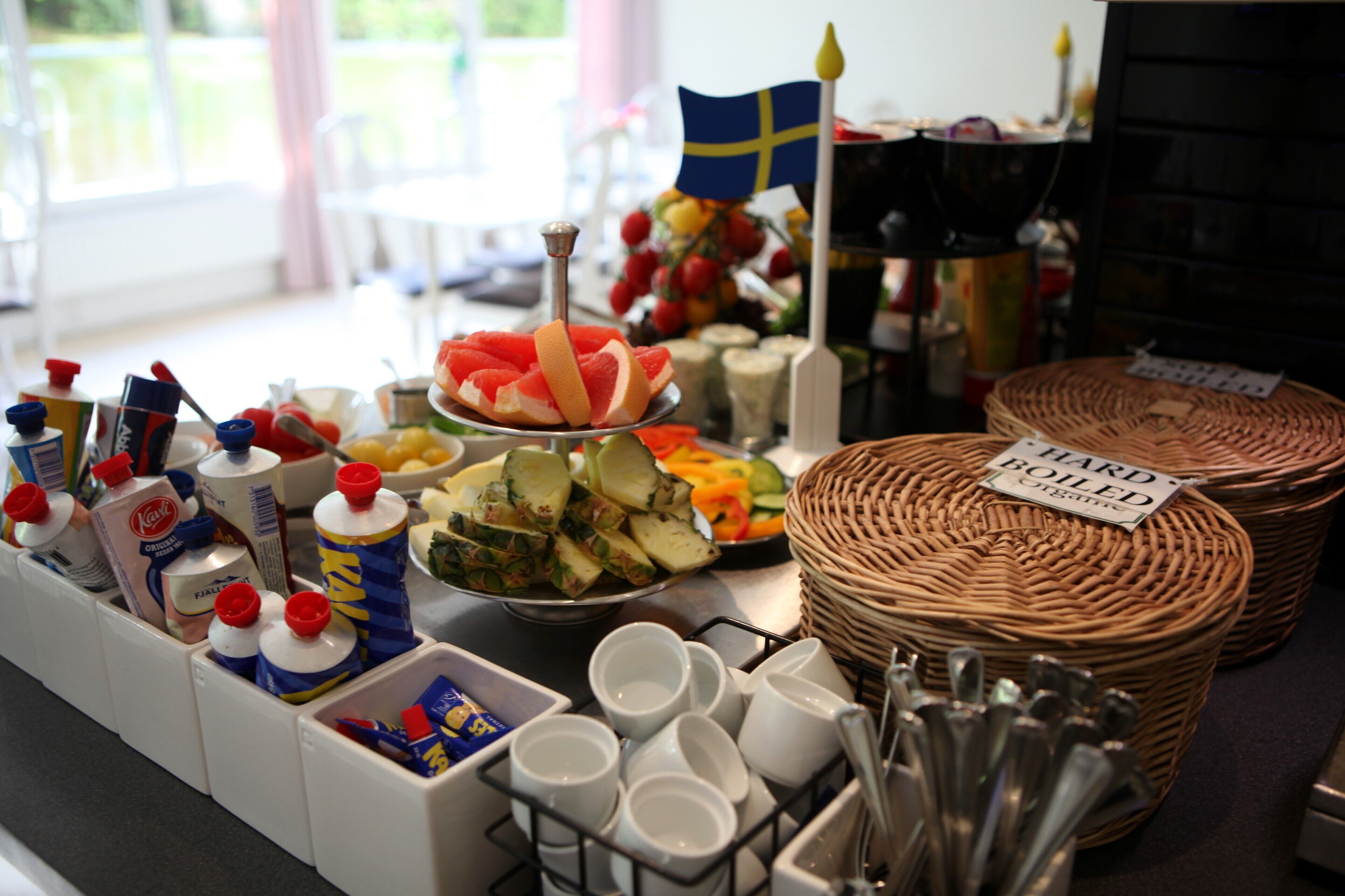 A buffet table with various food items, condiments, and utensils.