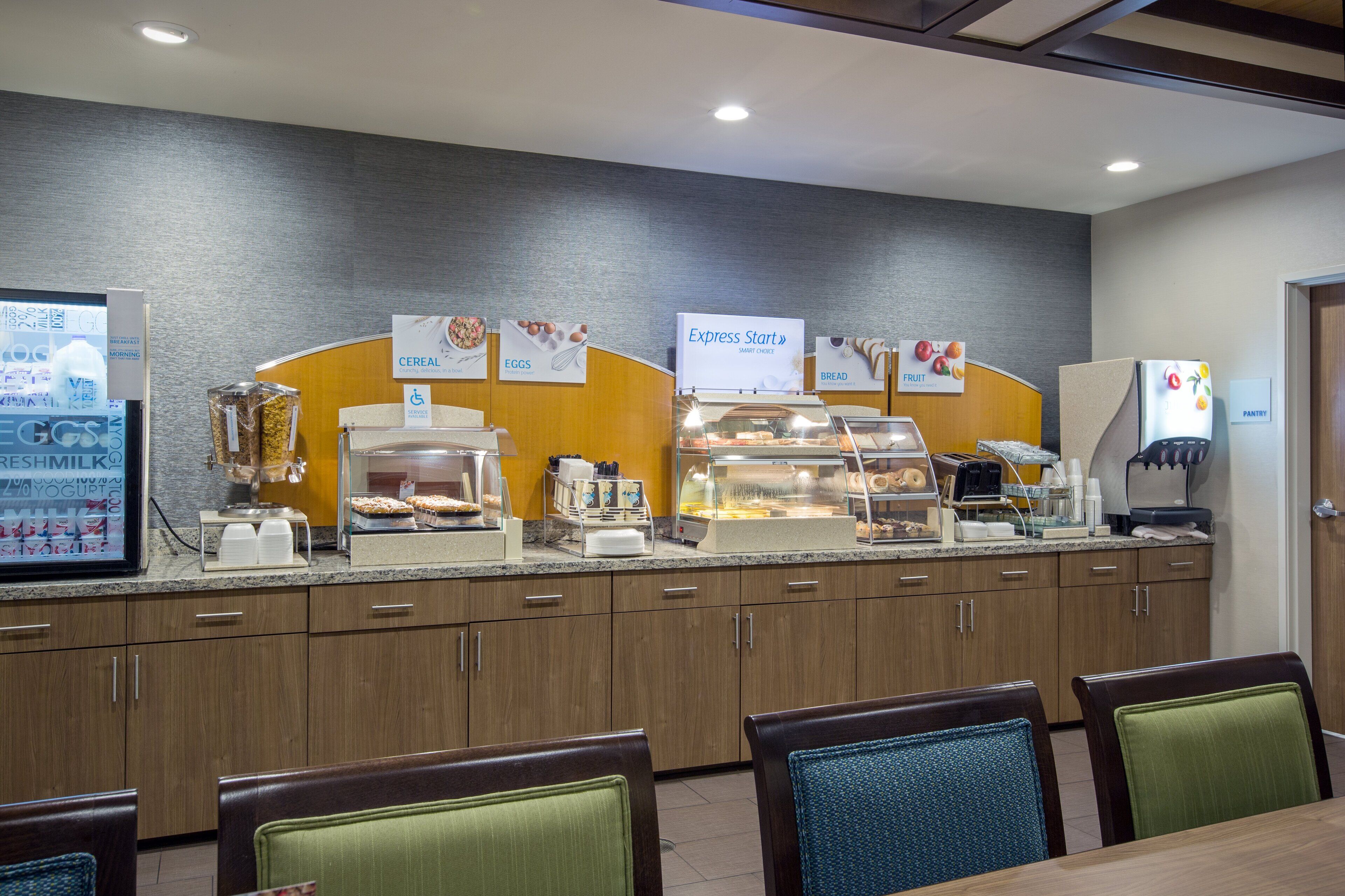 A breakfast bar with labeled sections for cereal, eggs, bread, and fruit.
