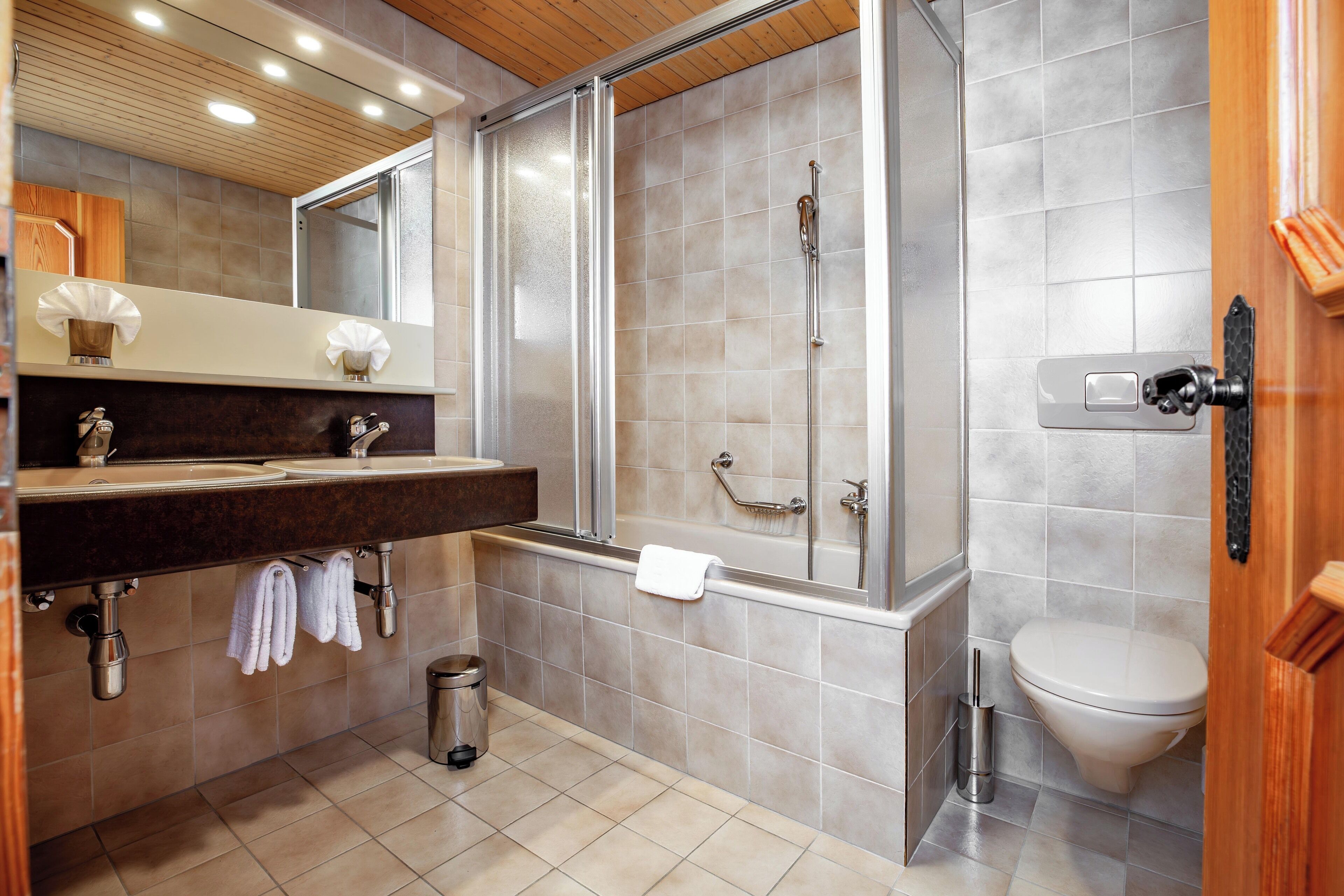 Une salle de bain moderne équipée d’une douche, de toilettes et d’un lavabo.