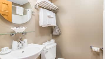 A bathroom with a sink, toilet, and towel rack.