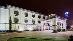 A Best Western hotel with a modern facade, multiple windows, and a well-lit entrance. - Best Western Jacksonville Inn (Jacksonville)