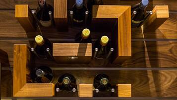 A wooden wine rack with bottles arranged in a grid pattern.