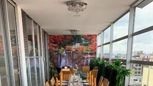 A long dining table set with plates, glasses, and folded napkins. - Hotel Macao Colombia (Bogotá)