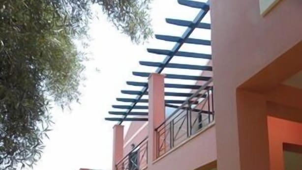 A modern two-story house with a covered patio and a well-maintained lawn. - Ionian Breeze Studios (Lefkada)