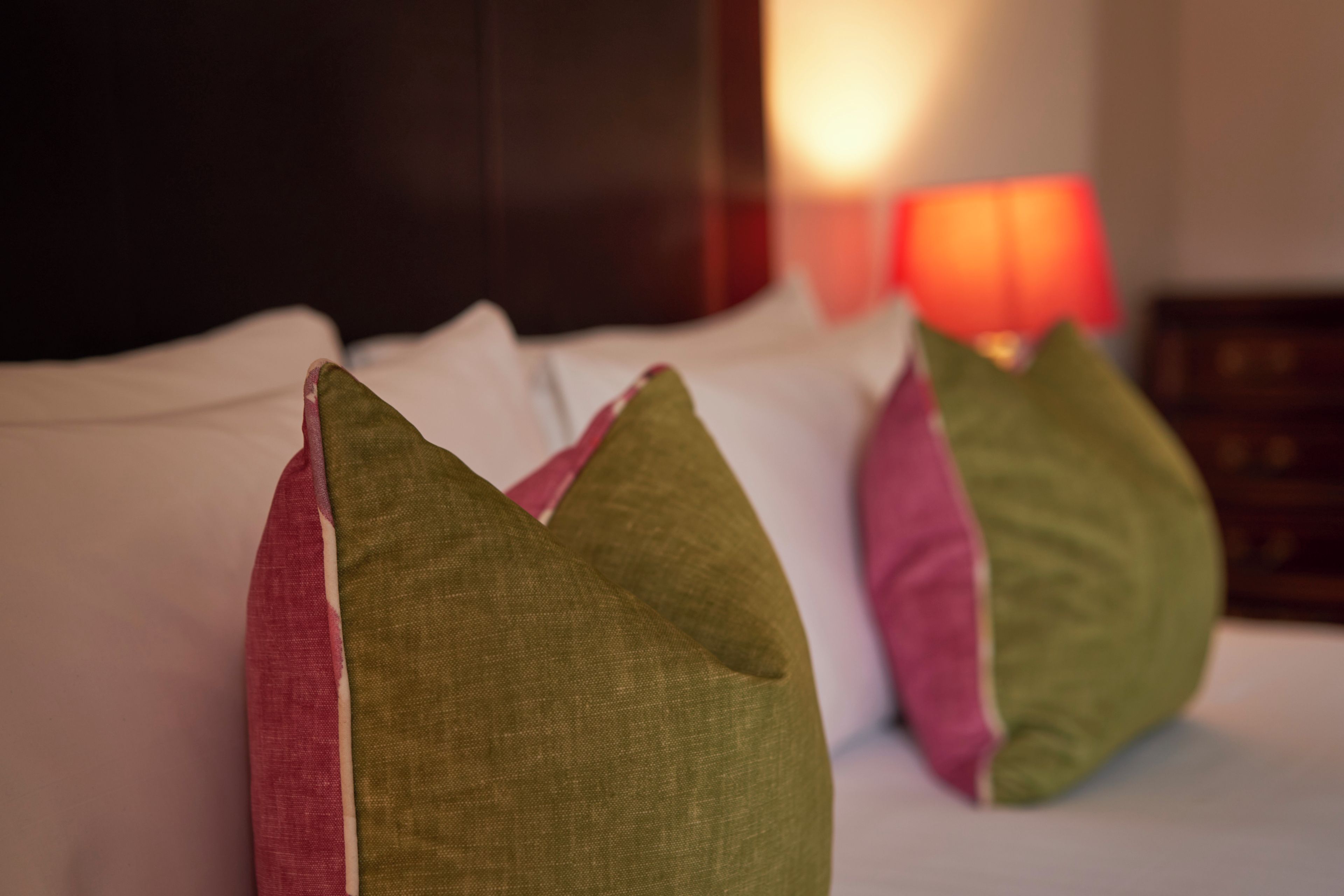 A bed with pillows and a nightstand.