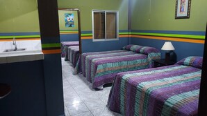A hotel room with four beds, a sink, a window, and a framed picture on the wall. - Hotel La Escalinata (Copan Ruinas)