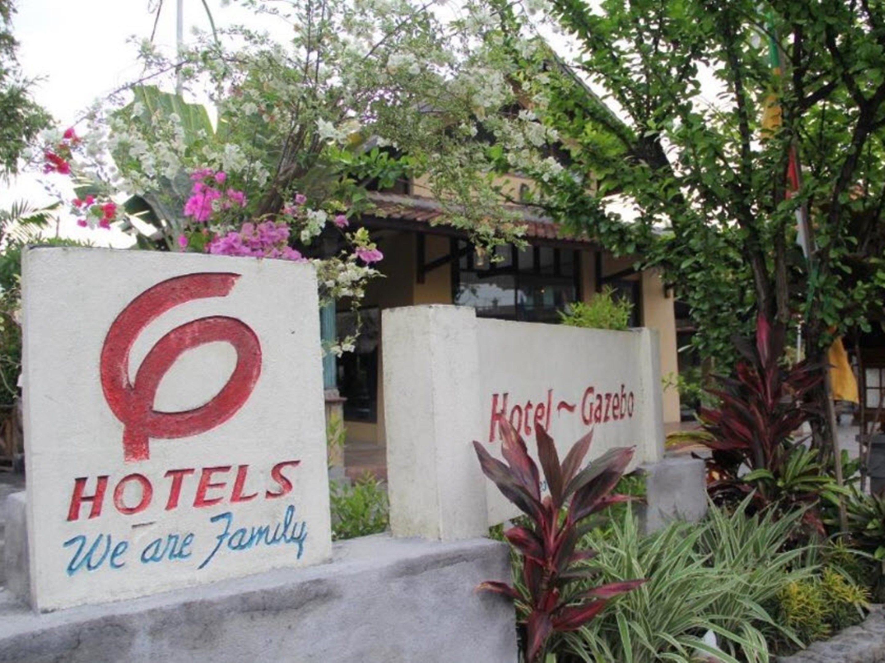 A sign for 'Hotel Gazebo' with a large number '6' and the words 'HOTELS We are Family' written on it.