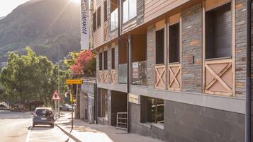 A multi-story hotel with a modern design, featuring balconies and large windows.