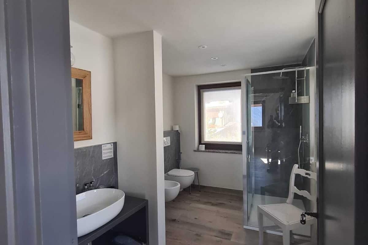 family suite | bathroom | shower, hair dryer, slippers, bidet