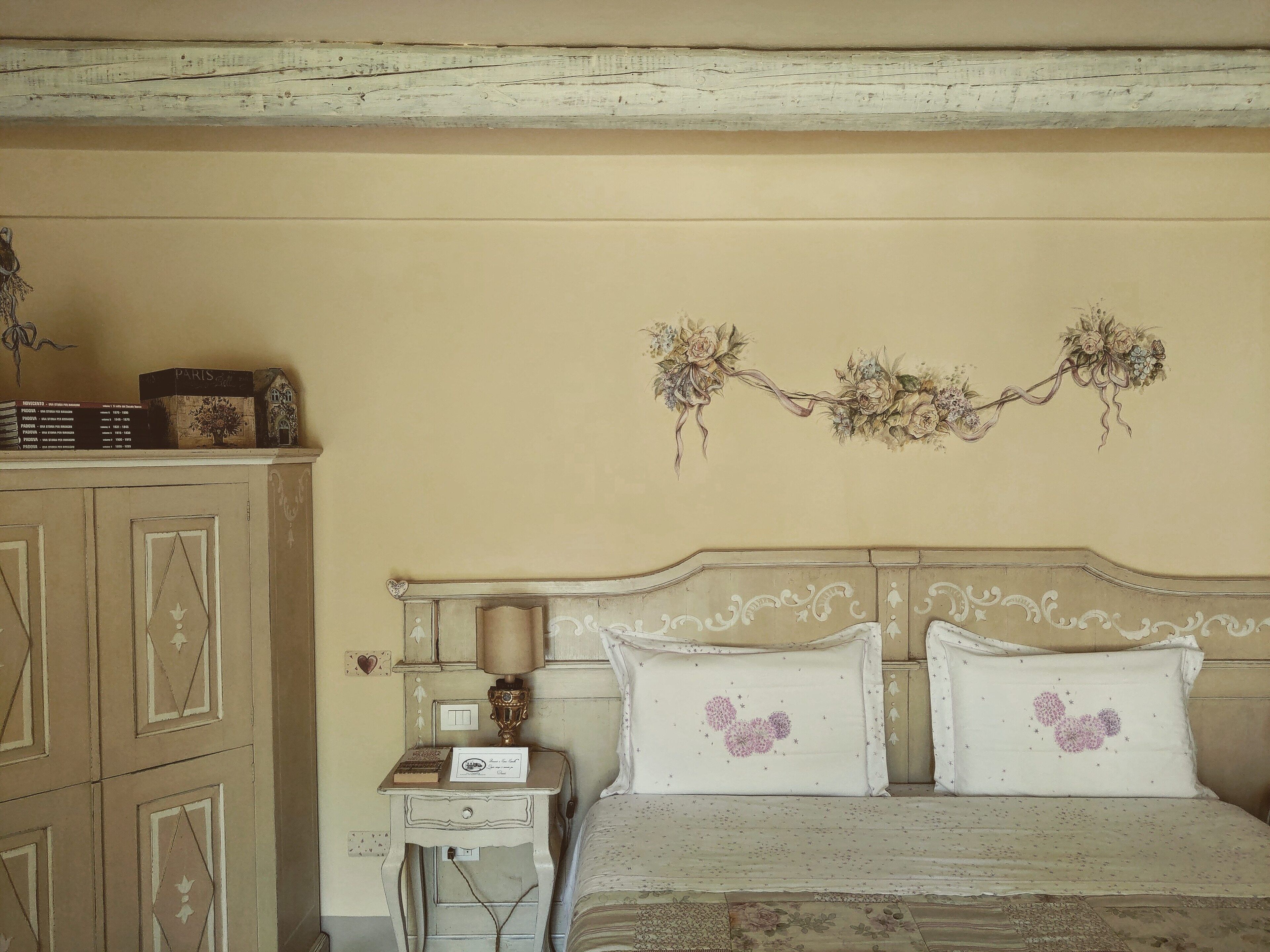A bedroom with a bed, nightstand, and dresser.