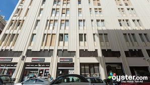 A multi-story building with commercial spaces on the ground floor, including a home theater and an office automation store. - OM2Rome (Rome)