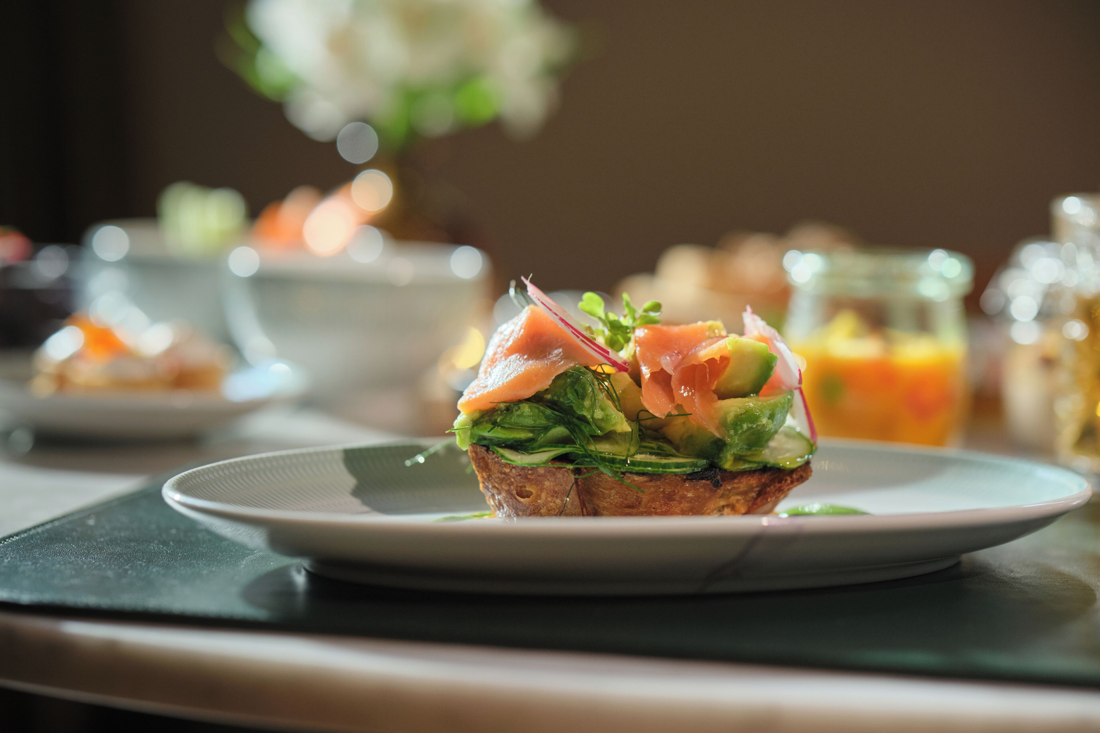 A sandwich on a plate with a blurred background.