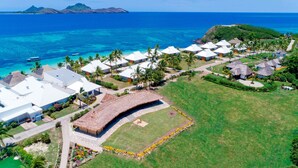 An aerial view of a resort with thatched-roof huts, a swimming pool, and a view of the ocean. - Sheraton Resort & Spa, Tokoriki Island, Fiji (Tokoriki Island)