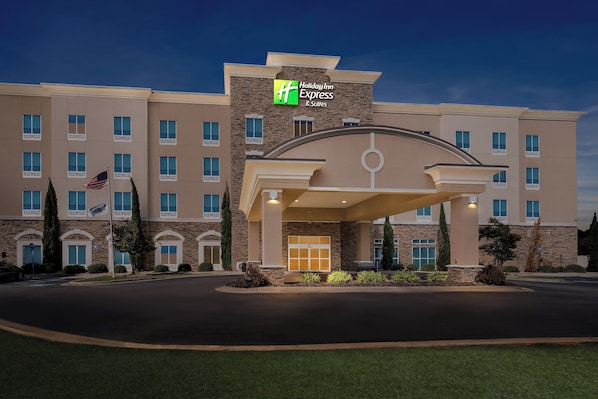 A Holiday Inn Express building with a modern design, featuring a prominent entrance and a flag. - Holiday Inn Express Hotel & Suites Albany by IHG (Albany)