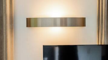 Un luminaire mural moderne, de forme rectangulaire et doté d’une finition métallique.