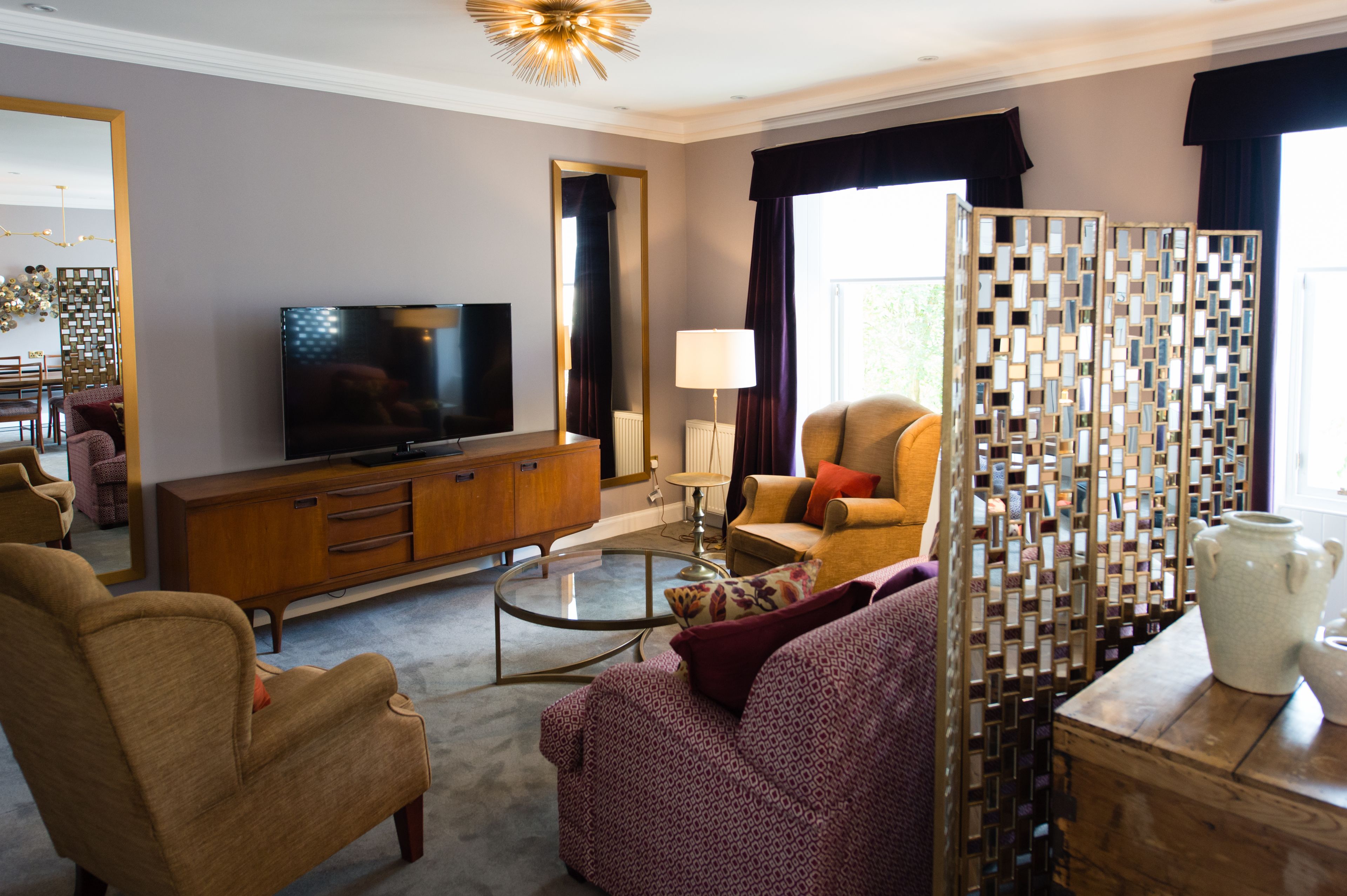 A modern living room with a television, sofa, and coffee table.