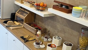 A breakfast buffet with various food items and condiments. - Adonis Arc Hôtel Aix (Aix-en-Provence)