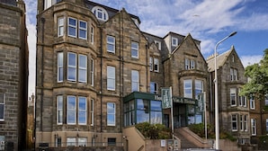 A historic building with multiple windows and a prominent entrance labeled "Hotel Vin & Bistro."