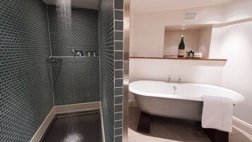 A bathroom with a shower, a bathtub, and a sink.