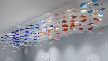 A ceiling with hanging glass ornaments in various shapes and sizes.
