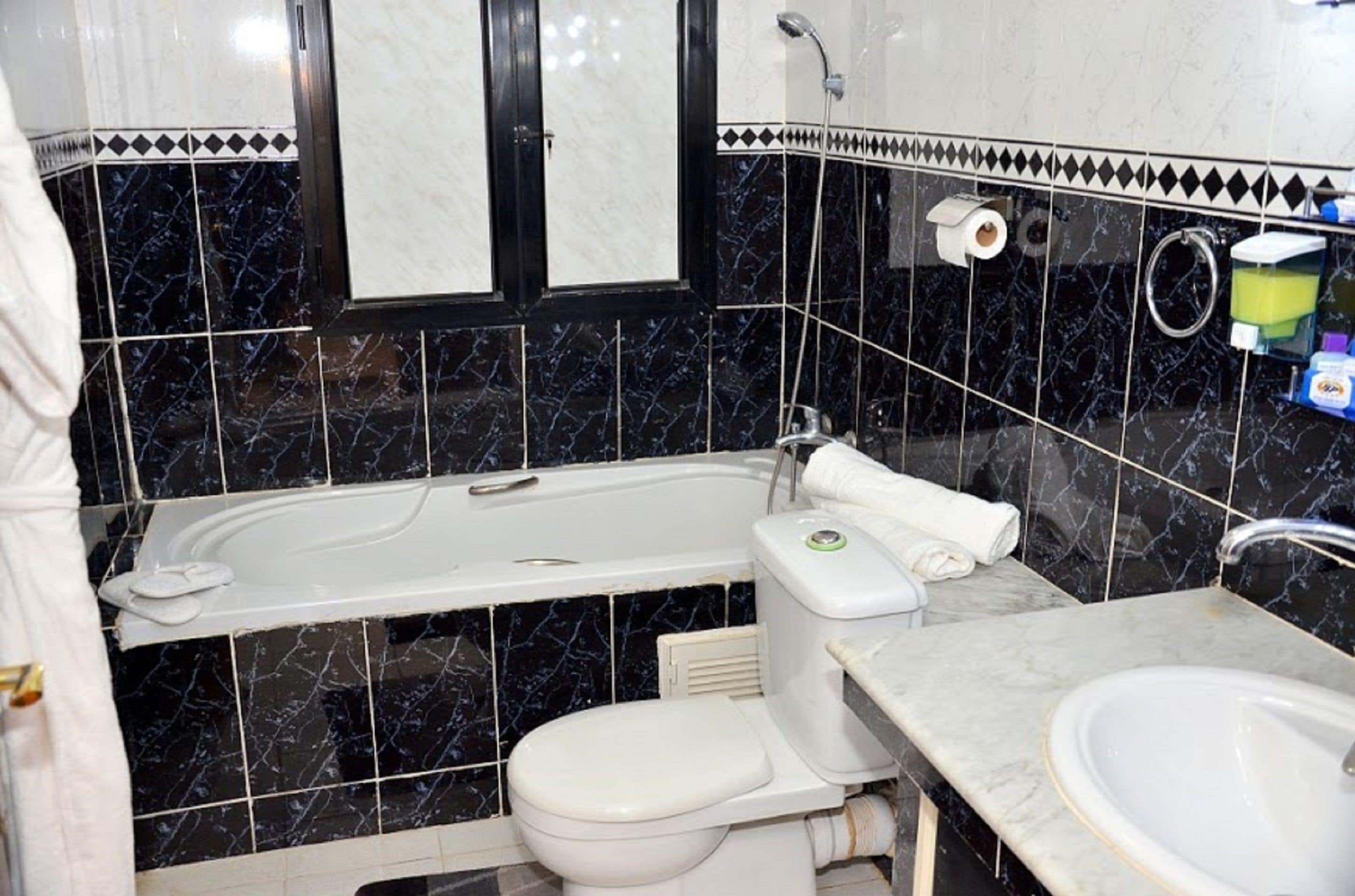 A bathroom with a bathtub, toilet, and sink.