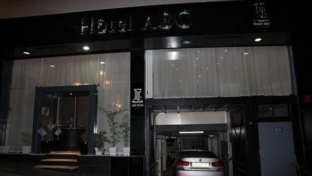 A hotel entrance with a car parked inside. - ABC Hotel (Algiers)