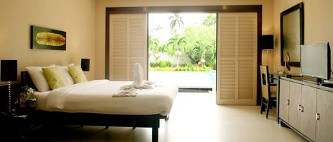 A 1-bed room with a bed, bedside table, TV, and a view of greenery outside.