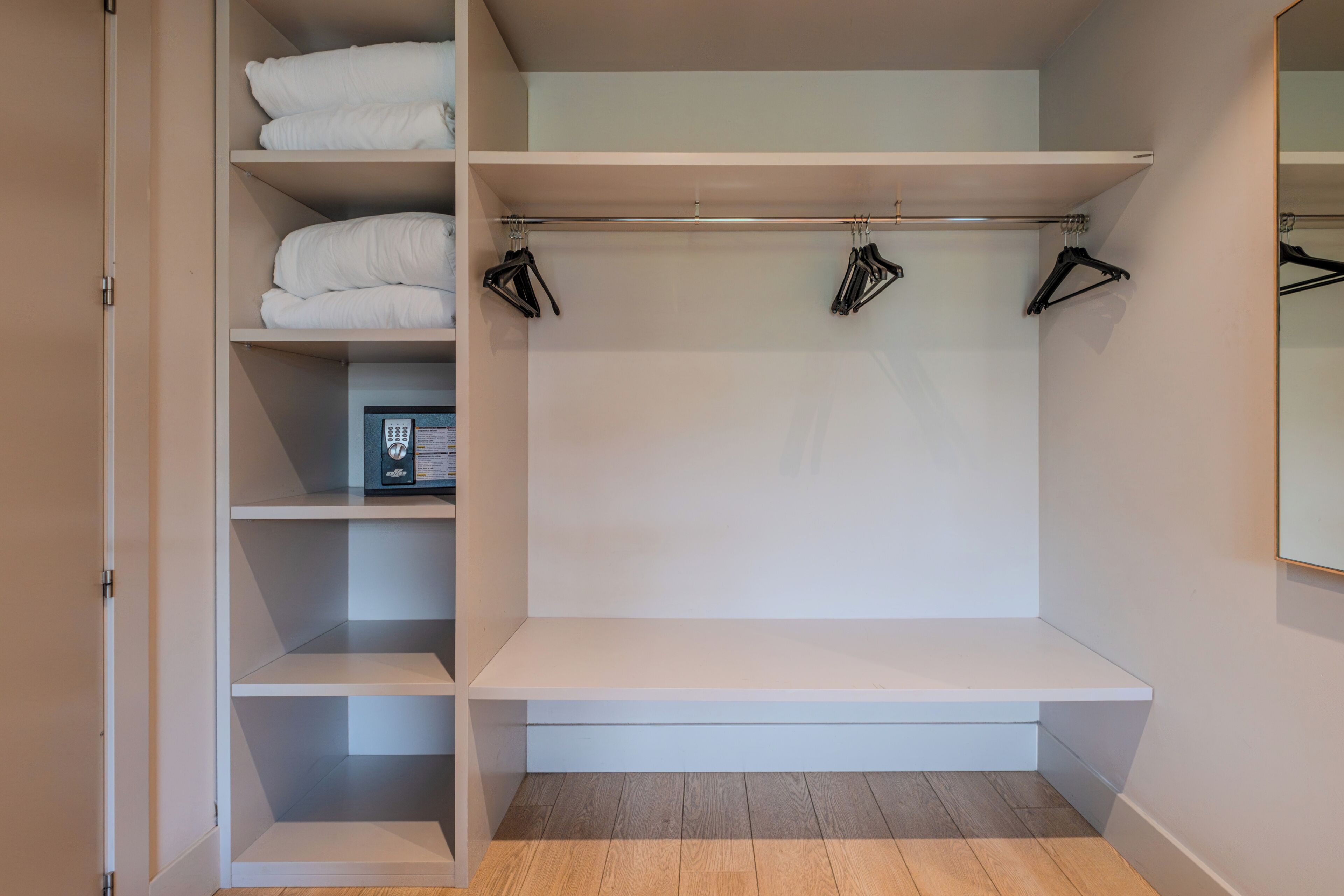 A walk-in closet with multiple shelves, a bench, and hanging space.