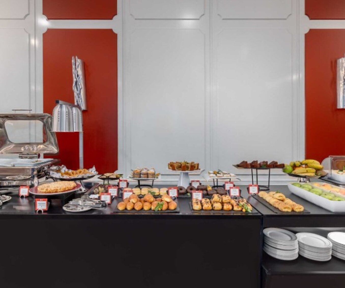 A buffet with various food items and a grill station.