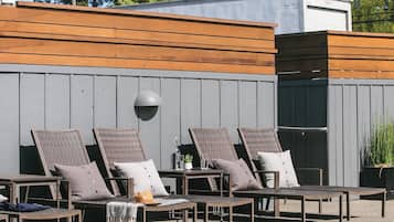 Una piscina al aire libre, sillones reclinables de piscina